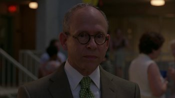 Movie still from “Lady in the Water” (2006), directed by M. Night Shyamalan – A person wearing a suit and tie; Close Up shot, Low angle