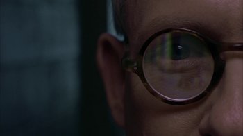 Movie still from “Lady in the Water” (2006), directed by M. Night Shyamalan – A person's eye wearing glasses; Extreme Close Up shot, Over the shoulder angle