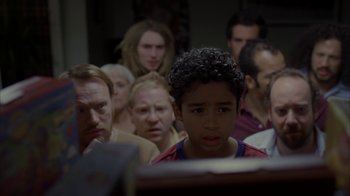 Movie still from “Lady in the Water” (2006), directed by M. Night Shyamalan – A group of people in a room with a boy looking at a computer screen; Close Up shot, Over the shoulder angle
