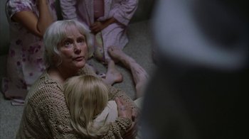 Movie still from “Lady in the Water” (2006), directed by M. Night Shyamalan – An older woman holding a baby in her arms; Close Up shot, High angle