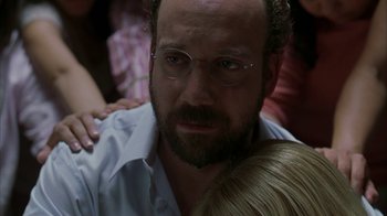 Movie still from “Lady in the Water” (2006), directed by M. Night Shyamalan – A person wearing glasses and a beard; Close Up shot, Over the shoulder angle