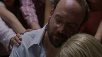 Movie still from “Lady in the Water” (2006), directed by M. Night Shyamalan – A person wearing a shirt and glasses; Close Up shot, Over the shoulder angle