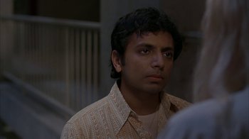 Movie still from “Lady in the Water” (2006), directed by M. Night Shyamalan – A person wearing a shirt; Close Up shot, Over the shoulder angle
