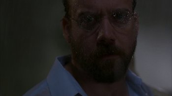 Movie still from “Lady in the Water” (2006), directed by M. Night Shyamalan – A person wearing glasses; Close Up shot, Low angle