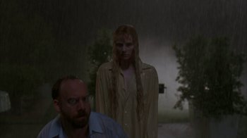 Movie still from “Lady in the Water” (2006), directed by M. Night Shyamalan – A man and a woman standing next to each other in the rain; Medium shot, Over the shoulder angle