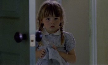Movie still from “Ladybird Ladybird” (1994), directed by Ken Loach – A little girl holding a towel in a room; Close Up shot, High angle