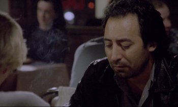 Movie still from “Ladybird Ladybird” (1994), directed by Ken Loach – A person sitting at a table; Close Up shot, Over the shoulder angle