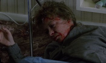 Movie still from “Ladybird Ladybird” (1994), directed by Ken Loach – A woman with a bloody head laying on the floor; Close Up shot, High angle