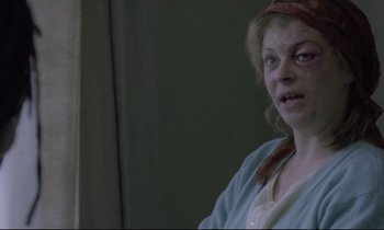 Movie still from “Ladybird Ladybird” (1994), directed by Ken Loach – A woman in a blue shirt is looking at the camera; Close Up shot, Over the shoulder angle