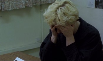 Movie still from “Ladybird Ladybird” (1994), directed by Ken Loach – A woman with her hands covering her face; Close Up shot, High angle