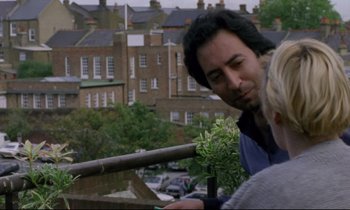 Movie still from “Ladybird Ladybird” (1994), directed by Ken Loach – A man and a woman looking at plants on a railing; Medium shot, Over the shoulder angle
