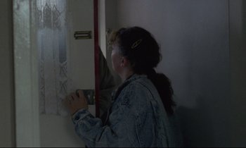 Movie still from “Ladybird Ladybird” (1994), directed by Ken Loach – A woman is taking a picture of herself in a mirror; Medium shot, Over the shoulder angle