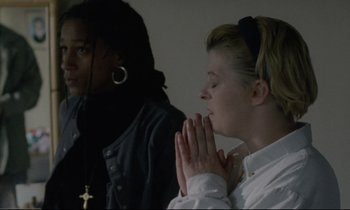Movie still from “Ladybird Ladybird” (1994), directed by Ken Loach – Two women are praying together in a room; Medium shot, High angle