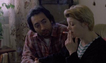 Movie still from “Ladybird Ladybird” (1994), directed by Ken Loach – A man and a woman are smoking a cigarette together; Close Up shot, Over the shoulder angle