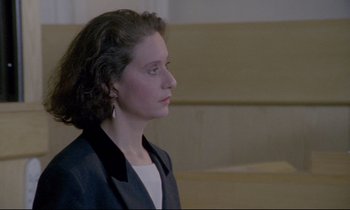 Movie still from “Ladybird Ladybird” (1994), directed by Ken Loach – A woman in a black jacket is looking to her left; Close Up shot, Low angle