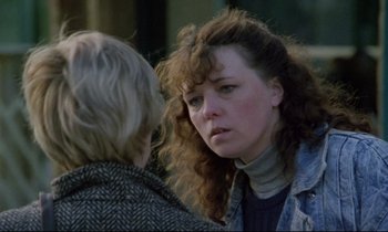 Movie still from “Ladybird Ladybird” (1994), directed by Ken Loach – A woman with curly hair talking to another woman; Close Up shot, Over the shoulder angle