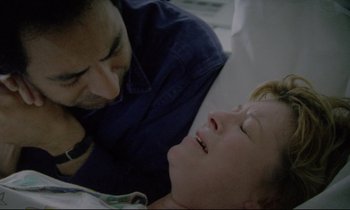 Movie still from “Ladybird Ladybird” (1994), directed by Ken Loach – A man and a woman laying in a bed together; Close Up shot, Overhead angle