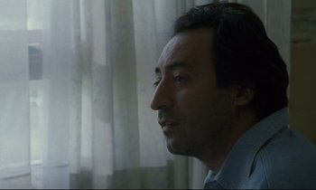 Movie still from “Ladybird Ladybird” (1994), directed by Ken Loach – A person looking out of a window; Close Up shot, Over the shoulder angle