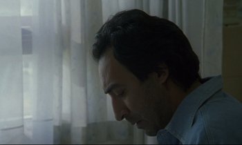 Movie still from “Ladybird Ladybird” (1994), directed by Ken Loach – A person looking down at his face; Close Up shot, Low angle