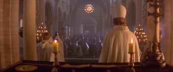 Movie still from “Ladyhawke” (1985), directed by Richard Donner – A group of people gathered in a large church; Wide shot, High angle