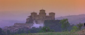 Movie still from “Ladyhawke” (1985), directed by Richard Donner – A castle like building on top of a hill; Extreme Wide shot, Low angle