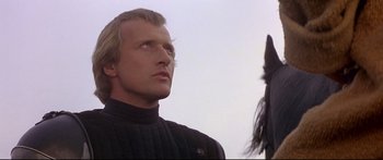 Movie still from “Ladyhawke” (1985), directed by Richard Donner – A person wearing a black jacket; Close Up shot, Low angle