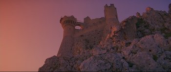 Movie still from “Ladyhawke” (1985), directed by Richard Donner – A very tall castle on top of a hill; Extreme Wide shot, Low angle