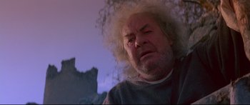 Movie still from “Ladyhawke” (1985), directed by Richard Donner – An old man with a white beard and white wig; Close Up shot, Low angle