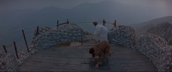 Movie still from “Ladyhawke” (1985), directed by Richard Donner – Two men are practicing martial arts on a wooden deck; Wide shot, High angle