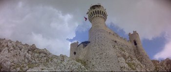 Movie still from “Ladyhawke” (1985), directed by Richard Donner – A man flying a kite on top of a tower; Extreme Wide shot, Low angle