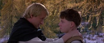 Movie still from “Ladyhawke” (1985), directed by Richard Donner – Two young men touching each other's heads in a forest; Close Up shot, Over the shoulder angle
