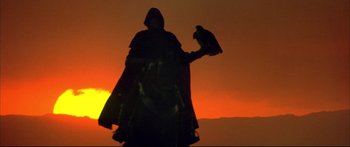 Movie still from “Ladyhawke” (1985), directed by Richard Donner – A person holding a bird on top of their hand; Wide shot, Low angle