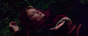 Movie still from “Ladyhawke” (1985), directed by Richard Donner – A woman laying on the ground in a blanket; Close Up shot, Overhead angle