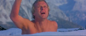 Movie still from “Ladyhawke” (1985), directed by Richard Donner – A shirtless man in the snow with his mouth wide open; Close Up shot, Low angle
