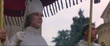 Movie still from “Ladyhawke” (1985), directed by Richard Donner – A man wearing a white outfit and a white hat; Close Up shot, Low angle