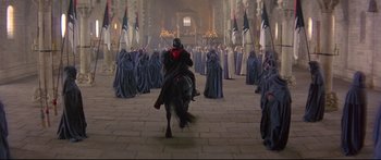 Movie still from “Ladyhawke” (1985), directed by Richard Donner – A group of people dressed up in robes and a horse; Extreme Wide shot, High angle