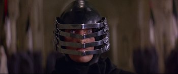 Movie still from “Ladyhawke” (1985), directed by Richard Donner – A man wearing a metal helmet and looking into the camera; Close Up shot, Low angle