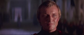 Movie still from “Ladyhawke” (1985), directed by Richard Donner – A person wearing a black shirt; Close Up shot, Low angle