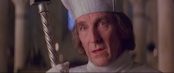 Movie still from “Ladyhawke” (1985), directed by Richard Donner – A man in a chef's hat holding a spatula; Close Up shot, Low angle
