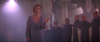 Movie still from “Ladyhawke” (1985), directed by Richard Donner – A group of men and a woman standing next to each other; Medium shot, Low angle