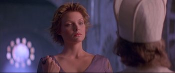 Movie still from “Ladyhawke” (1985), directed by Richard Donner – A woman in a purple dress looking into a mirror; Close Up shot, Over the shoulder angle