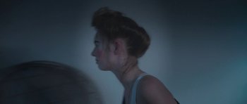 Movie still from “Ladyworld” (2018), directed by Amanda Kramer – A woman with red hair is looking into the distance; Close Up shot, Low angle