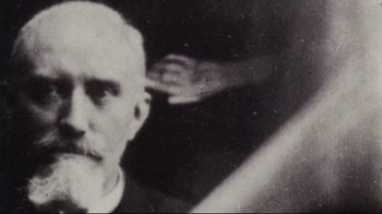 Movie still from “Lake Mungo” (2008), directed by Joel Anderson – An old photo of an older man with a bald head; Extreme Close Up shot, Low angle