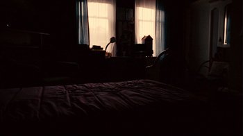 Movie still from “Lake Mungo” (2008), directed by Joel Anderson – A bed room with a bed and two windows; Wide shot, High angle