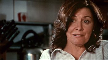 Movie still from “Lake Mungo” (2008), directed by Joel Anderson – An older woman in a white shirt is looking at the camera; Close Up shot, Low angle