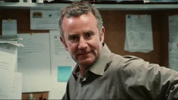 Movie still from “Lake Mungo” (2008), directed by Joel Anderson – A person wearing a gray shirt; Close Up shot, Over the shoulder angle