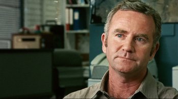 Movie still from “Lake Mungo” (2008), directed by Joel Anderson – A person wearing a brown shirt; Close Up shot, Over the shoulder angle