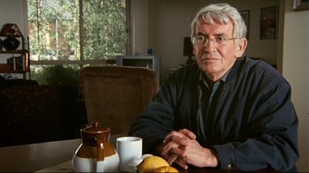 Movie still from “Lake Mungo” (2008), directed by Joel Anderson – An older man sitting at a table with a cup of tea; Close Up shot, Low angle
