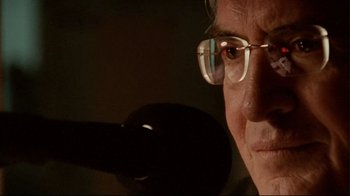 Movie still from “Lake Mungo” (2008), directed by Joel Anderson – An older man wearing glasses looking at the camera; Extreme Close Up shot, Low angle