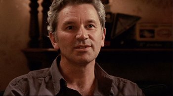 Movie still from “Lake Mungo” (2008), directed by Joel Anderson – A person wearing a black shirt; Close Up shot, Over the shoulder angle